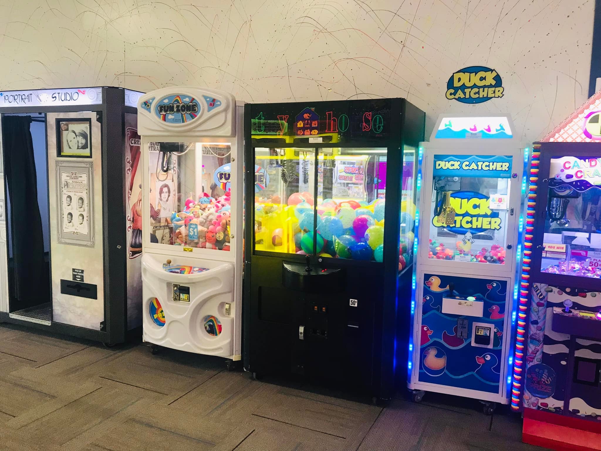 Arcade claw machines with colorful prizes at Newport Entertainment Center