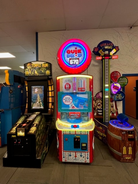 Vintage arcade games neon lit display at Newport Entertainment Center